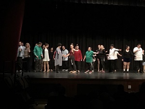 A group of people dance on a stage