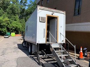 A mobile trailer with stairs leading up to it